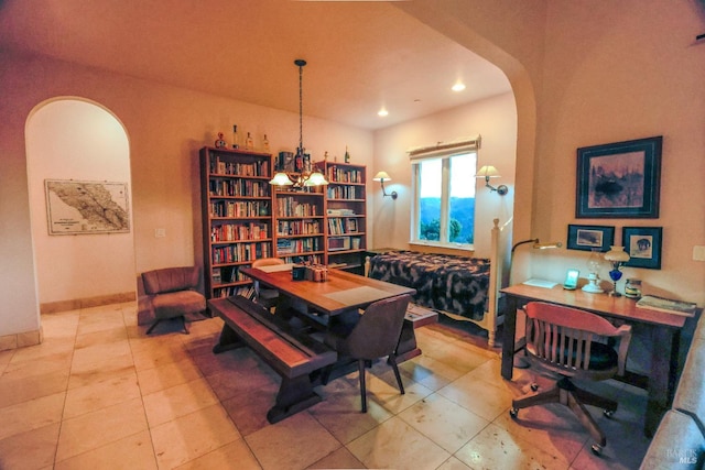 dining area featuring a notable chandelier and light tile floors