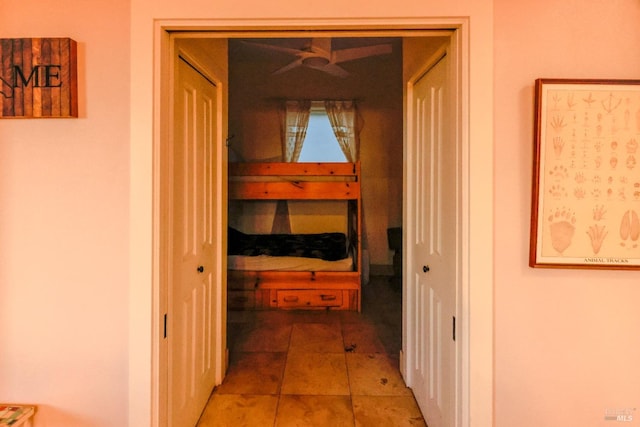 corridor featuring light tile floors