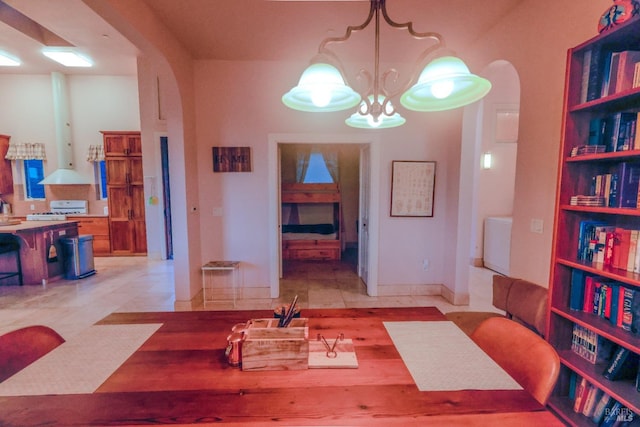 sitting room with a notable chandelier, washer / clothes dryer, and light tile floors