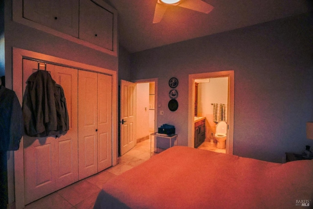 tiled bedroom featuring ceiling fan, connected bathroom, and a closet