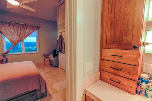 tiled bedroom featuring ceiling fan