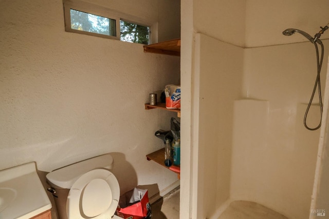 bathroom with a shower, toilet, and vanity