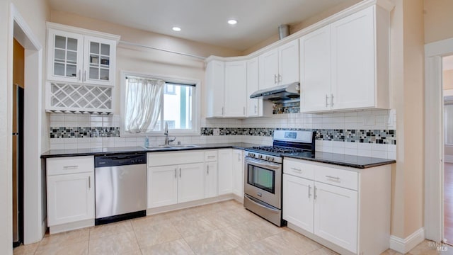 kitchen featuring white cabinets, appliances with stainless steel finishes, tasteful backsplash, and sink