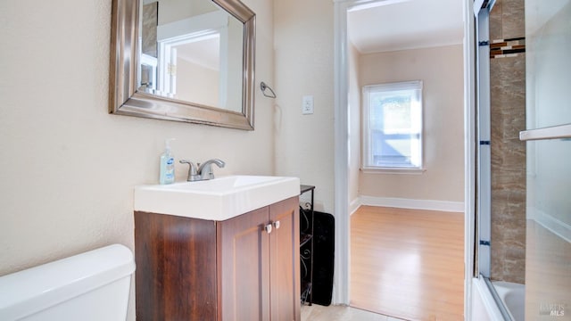 full bathroom featuring wood-type flooring, toilet, enclosed tub / shower combo, and vanity