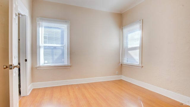 empty room featuring plenty of natural light and light wood-type flooring