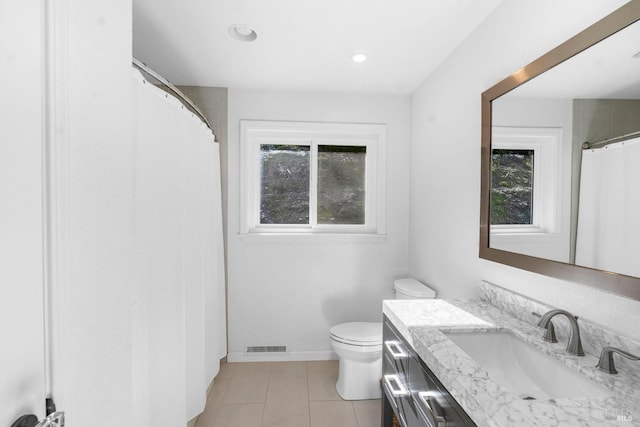 bathroom with toilet, tile floors, and vanity