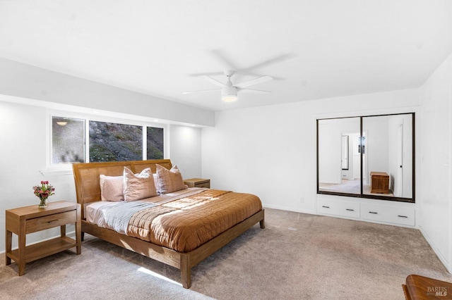 carpeted bedroom with ceiling fan and a closet