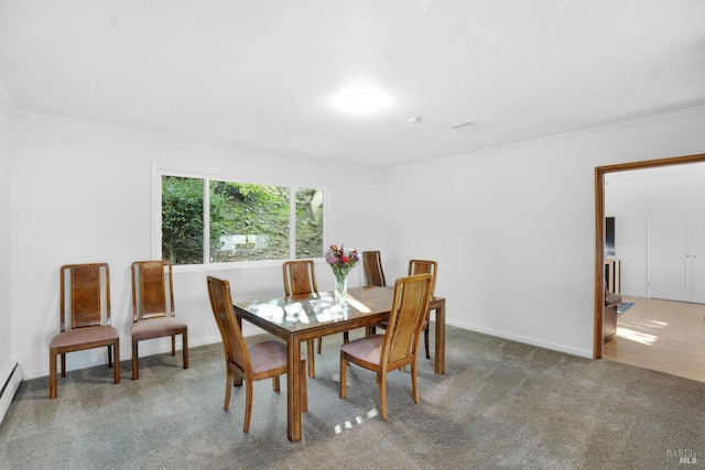 carpeted dining space featuring baseboard heating and crown molding