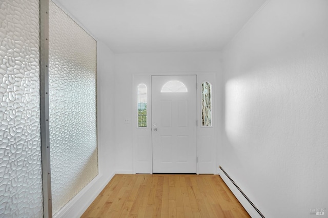 entryway with baseboard heating and light wood-type flooring