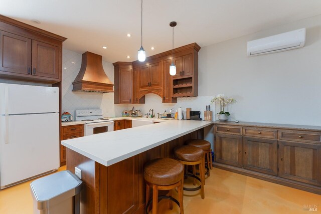 kitchen with a breakfast bar area, custom range hood, a wall mounted AC, backsplash, and white appliances