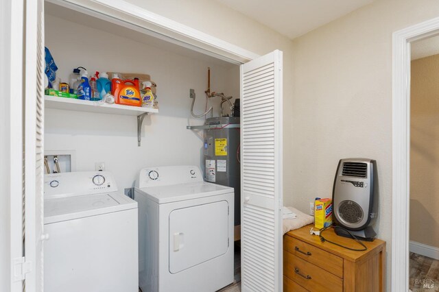 laundry area with hardwood / wood-style flooring, separate washer and dryer, and water heater