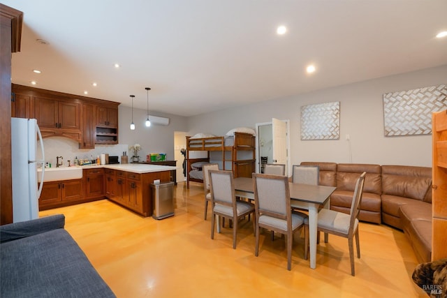 dining space with light hardwood / wood-style floors and sink