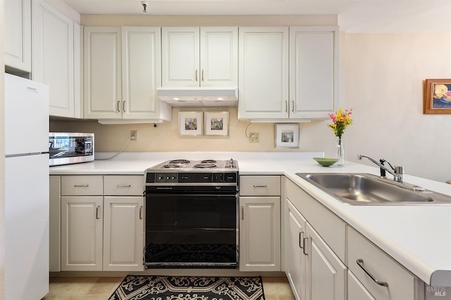 kitchen featuring range with electric stovetop, white cabinetry, white refrigerator, and sink