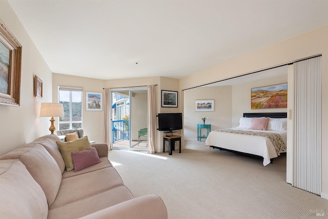 carpeted bedroom featuring access to outside