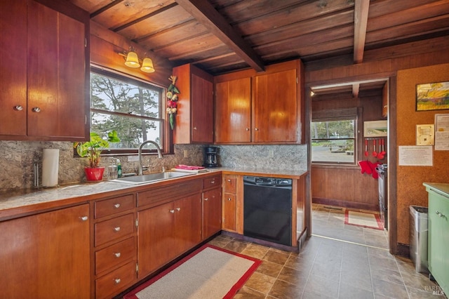 kitchen featuring black dishwasher, beamed ceiling, a healthy amount of sunlight, and sink