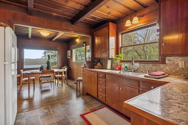 kitchen featuring beamed ceiling, wood ceiling, dark hardwood / wood-style flooring, white fridge, and decorative backsplash