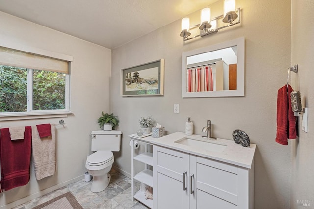 bathroom featuring toilet and vanity