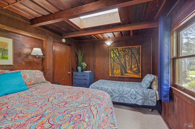 bedroom with wood ceiling, carpet floors, wooden walls, beamed ceiling, and a skylight