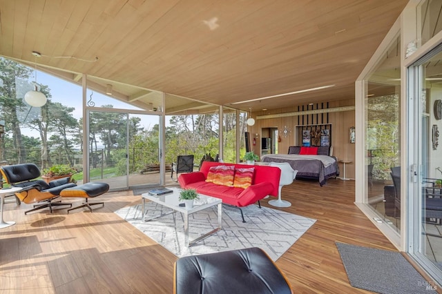 sunroom / solarium with lofted ceiling and wooden ceiling