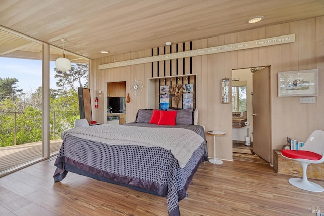 bedroom featuring wooden ceiling, wood-type flooring, and wooden walls