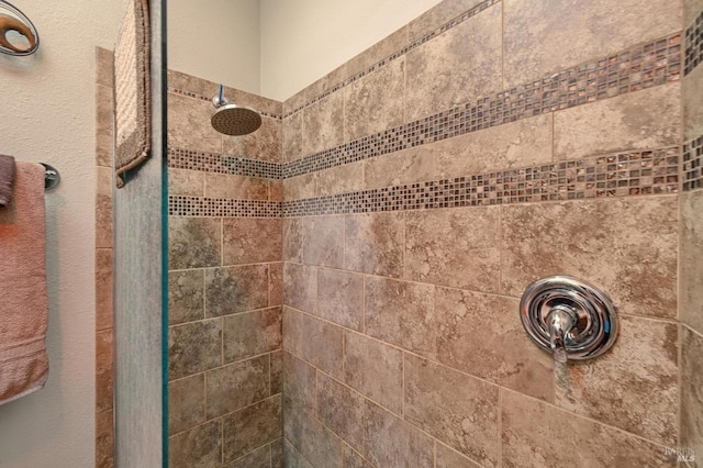 bathroom with a tile shower