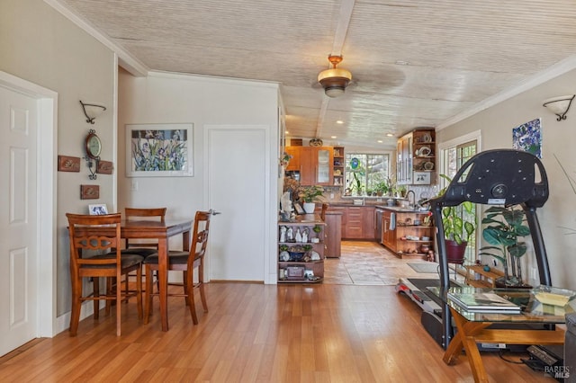 interior space with light wood-type flooring and crown molding