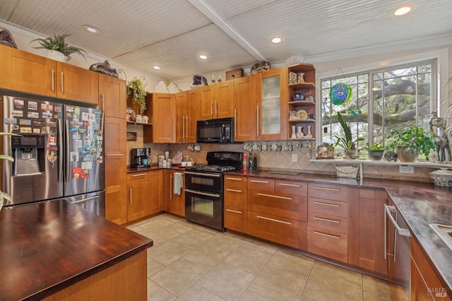 kitchen with tasteful backsplash, light tile patterned floors, black appliances, and ornamental molding