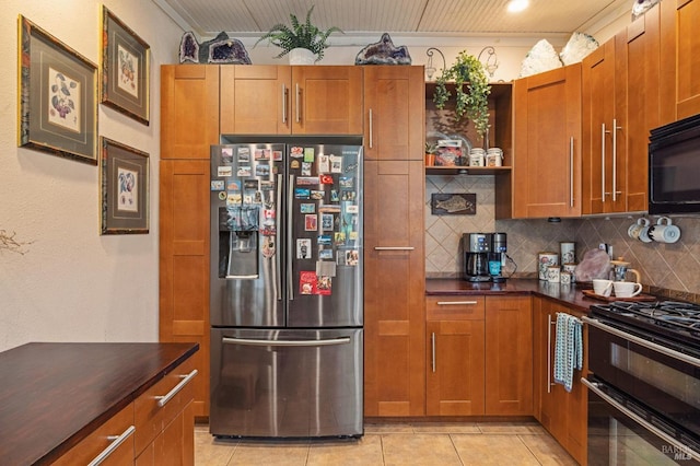 kitchen with light tile patterned flooring, tasteful backsplash, stainless steel fridge with ice dispenser, and stove