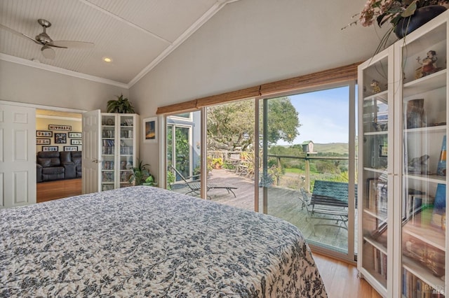 bedroom featuring ornamental molding, multiple windows, lofted ceiling, and access to outside