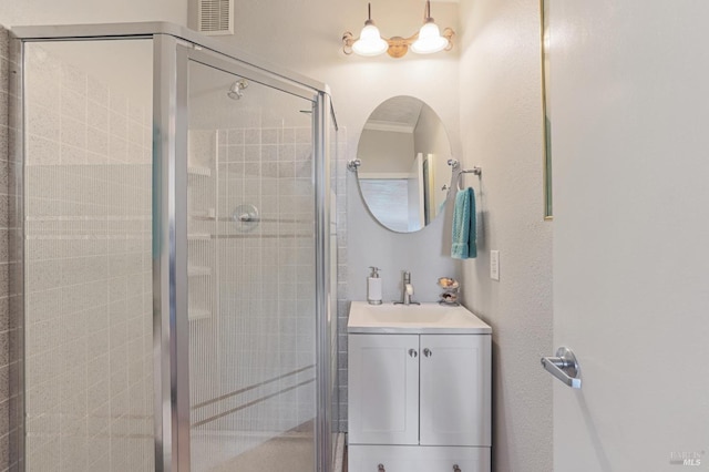 bathroom with walk in shower and vanity