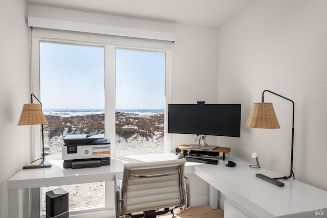 home office with a healthy amount of sunlight and wood finished floors