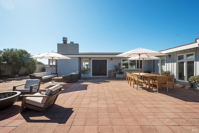 view of patio / terrace with fence, outdoor dining space, and an outdoor hangout area