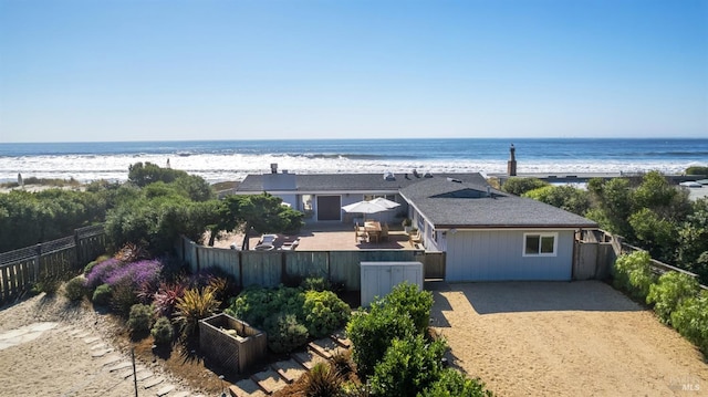 exterior space featuring fence private yard and a view of the beach