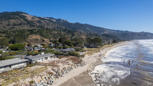 exterior space featuring a view of the beach and a water and mountain view