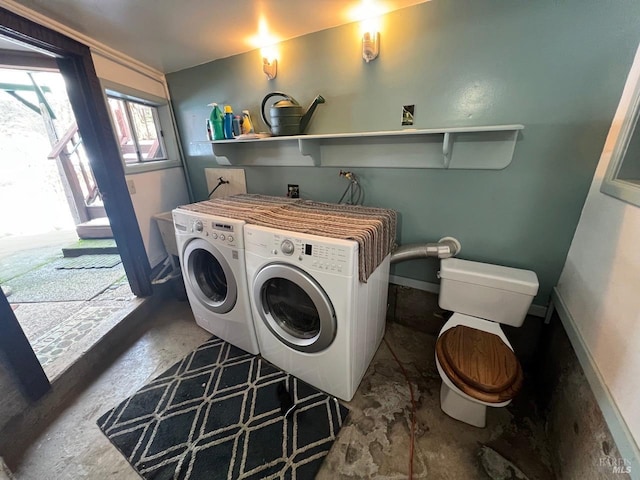 clothes washing area featuring washer and clothes dryer