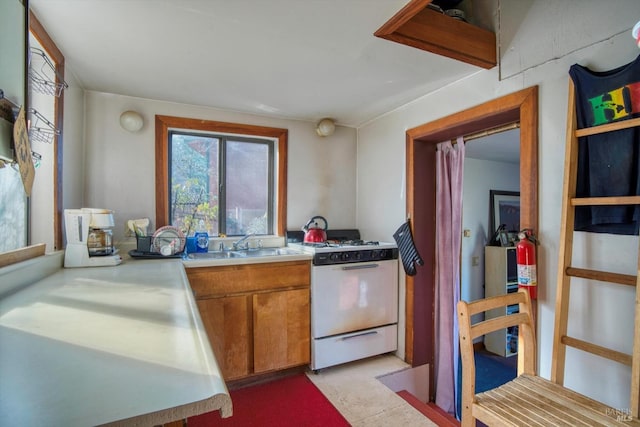 kitchen featuring sink and white gas range oven