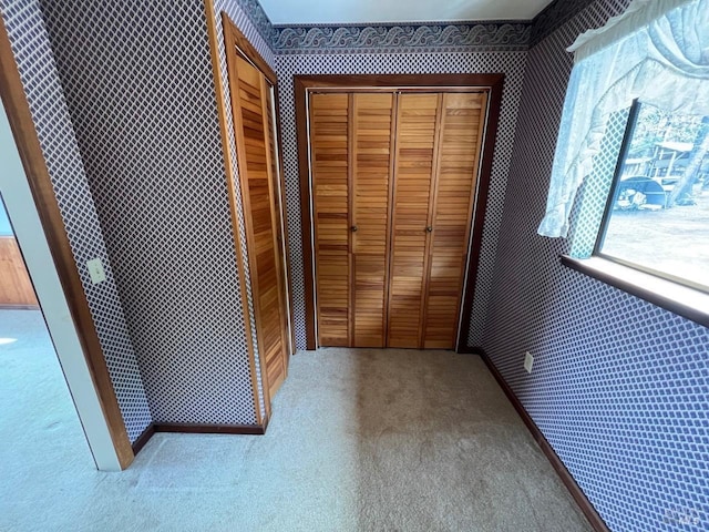 hallway with light colored carpet