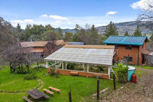 surrounding community featuring a mountain view and an outbuilding