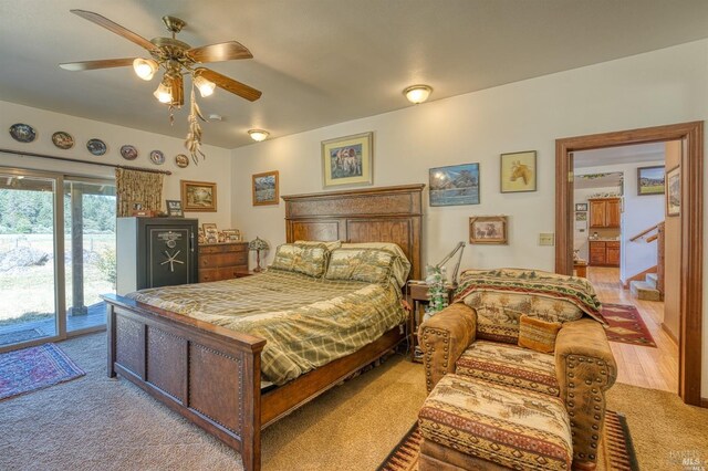 bedroom with light hardwood / wood-style flooring, ceiling fan, and access to outside