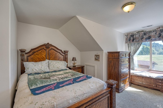 bedroom featuring carpet floors and vaulted ceiling