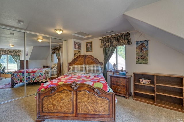 carpeted bedroom with vaulted ceiling, a closet, and a textured ceiling