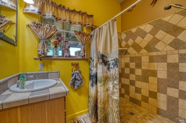 bathroom featuring vanity and a shower with shower curtain