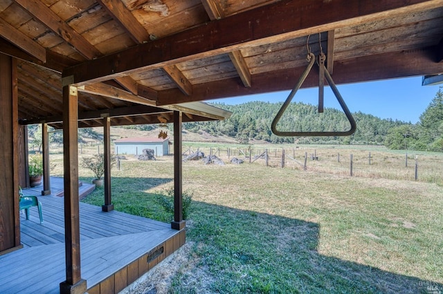 view of yard featuring a rural view and a deck