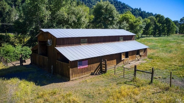 view of horse barn featuring a rural view