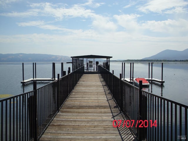 dock area featuring a water and mountain view