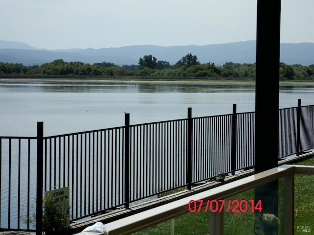 water view with fence and a mountain view