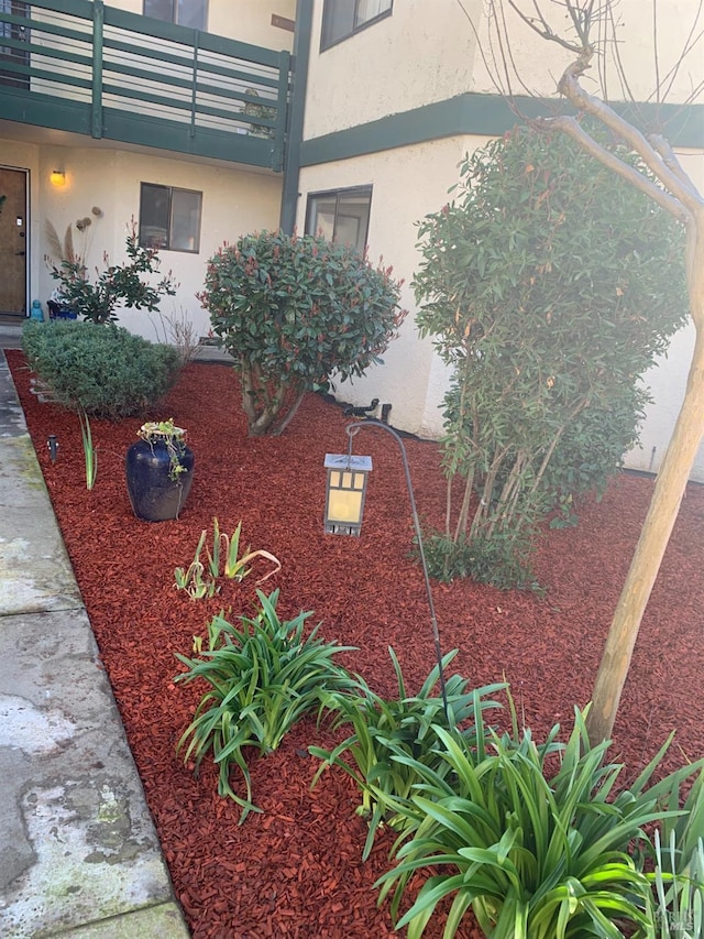 exterior space with a balcony and stucco siding