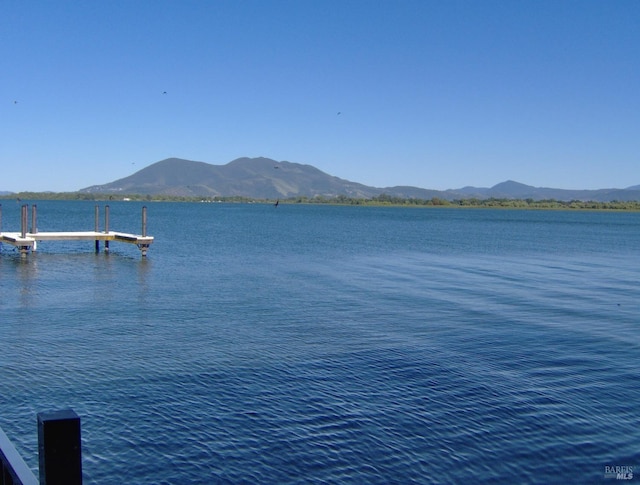 view of water feature featuring a boat dock and a mountain view