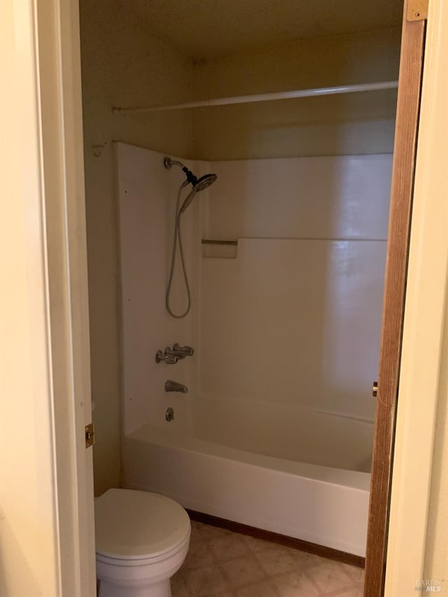 full bath with toilet, tile patterned floors, and bathing tub / shower combination