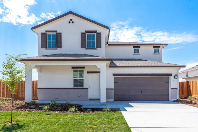 view of front of home with a garage and a front lawn